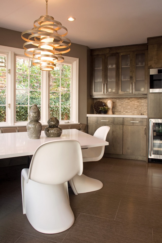 Photo of a contemporary eat-in kitchen in Other with flat-panel cabinets, dark wood cabinets, an undermount sink, concrete benchtops, grey splashback, stone tile splashback, stainless steel appliances, porcelain floors and with island.