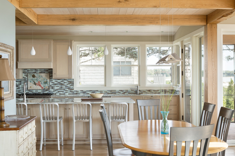 Design ideas for a beach style kitchen in Portland Maine with shaker cabinets, light wood cabinets, multi-coloured splashback, matchstick tile splashback, light hardwood floors and with island.
