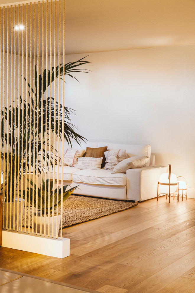 Inspiration for a mediterranean living room in Barcelona with light hardwood floors.