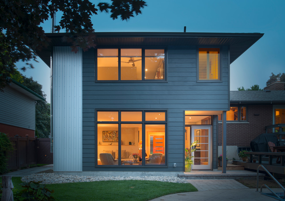 Design ideas for a modern split-level grey exterior in Toronto with concrete fiberboard siding.