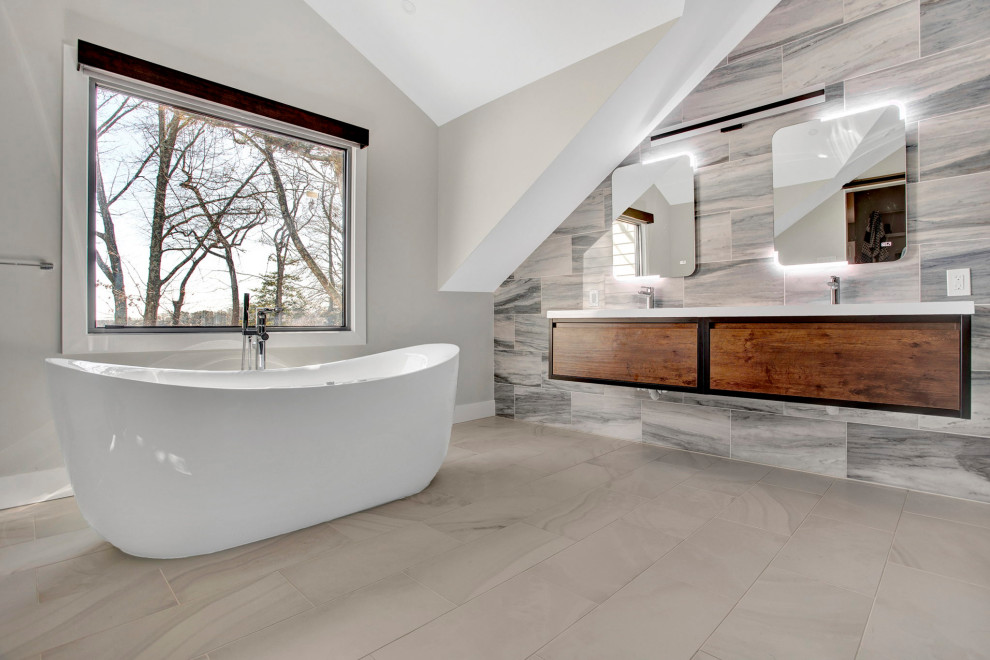 Inspiration for a huge modern master blue tile double-sink and vaulted ceiling freestanding bathtub remodel in Philadelphia with flat-panel cabinets, brown cabinets, gray walls, an undermount sink, quartz countertops, white countertops and a floating vanity