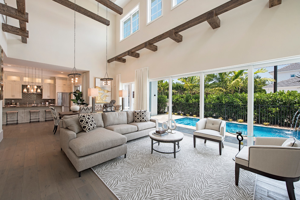 Inspiration for a transitional open concept living room in Miami with beige walls and medium hardwood floors.
