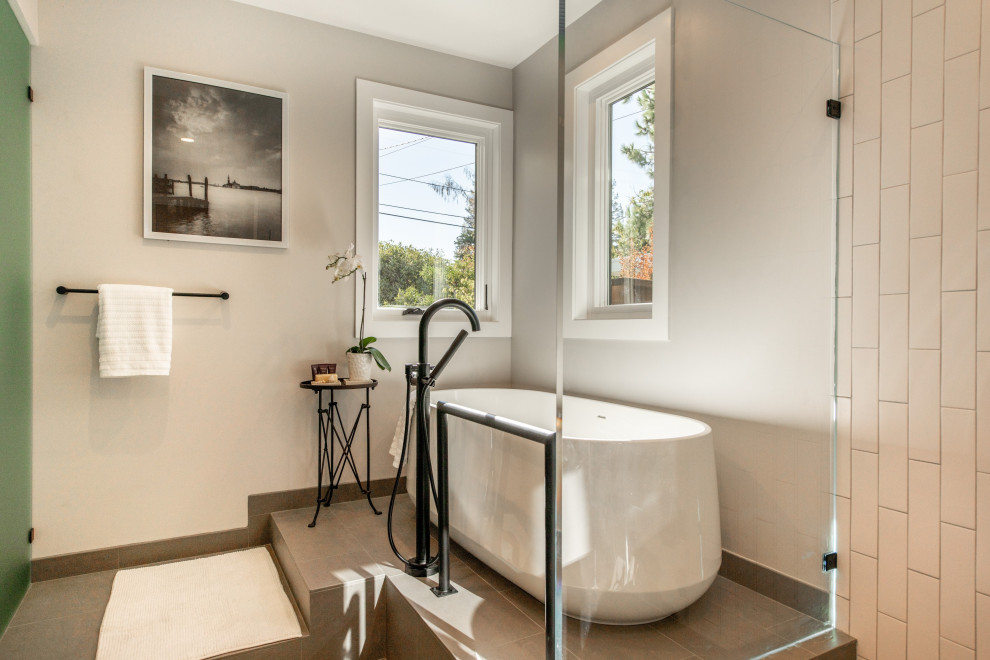 Large modern ensuite bathroom in San Francisco with open cabinets, a freestanding bath, a walk-in shower, a built-in sink, an enclosed toilet, double sinks and a floating vanity unit.