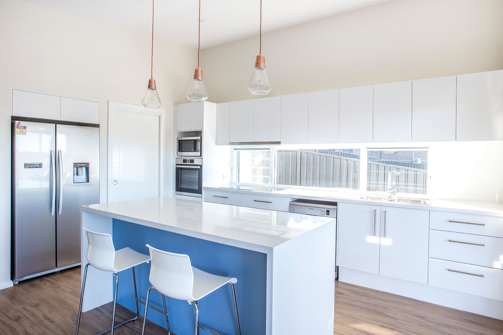 Inspiration for a mid-sized contemporary l-shaped open plan kitchen in Wollongong with a double-bowl sink, flat-panel cabinets, white cabinets, granite benchtops, window splashback, stainless steel appliances, dark hardwood floors and with island.