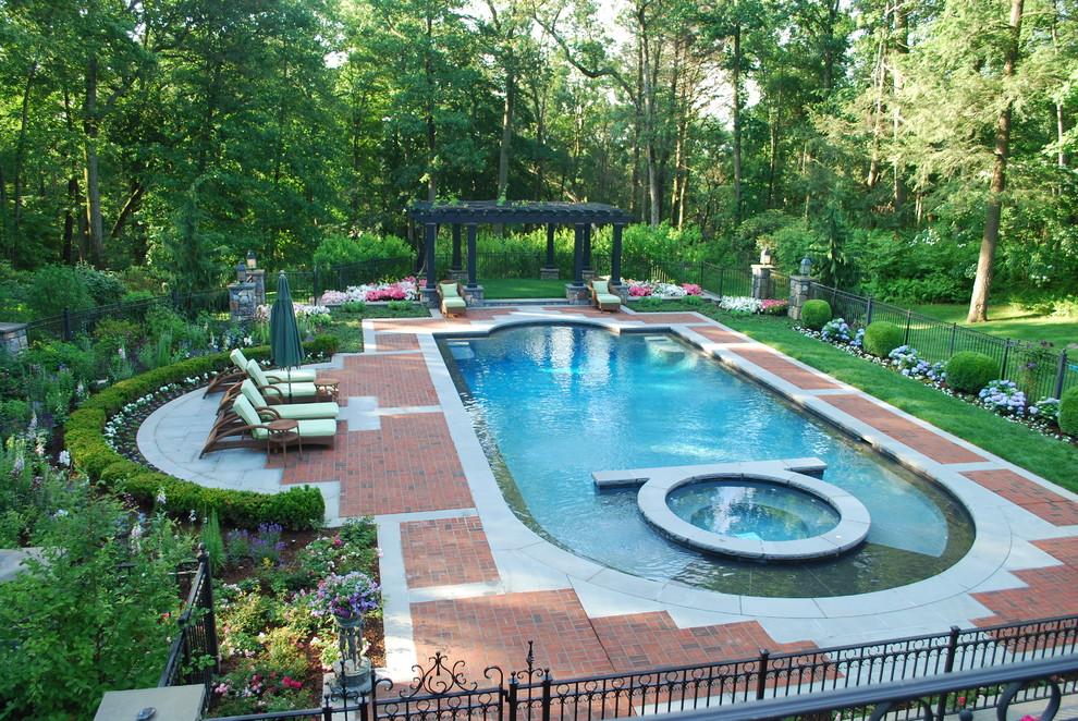 Inspiration for a traditional pool in New York with brick pavers.