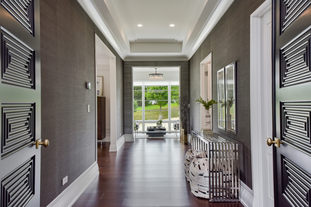 Inspiration for a large modern hallway in Chicago with brown walls, dark hardwood floors, brown floor, coffered and wallpaper.