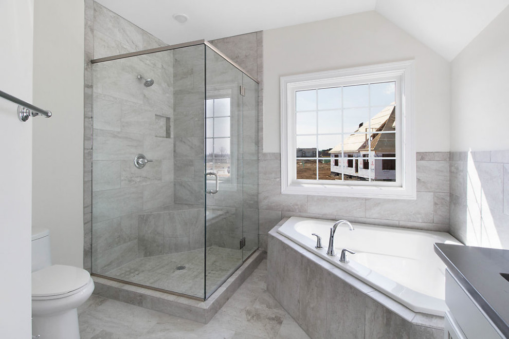Photo of a mid-sized transitional master bathroom in Other with recessed-panel cabinets, grey cabinets, a corner tub, a corner shower, gray tile, ceramic tile, engineered quartz benchtops, a hinged shower door, white benchtops, a double vanity and a built-in vanity.