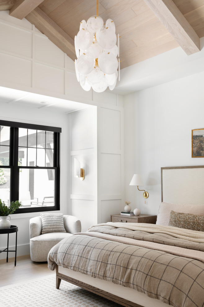 Example of a transitional light wood floor, beige floor, exposed beam, vaulted ceiling, wood ceiling and wall paneling bedroom design with white walls