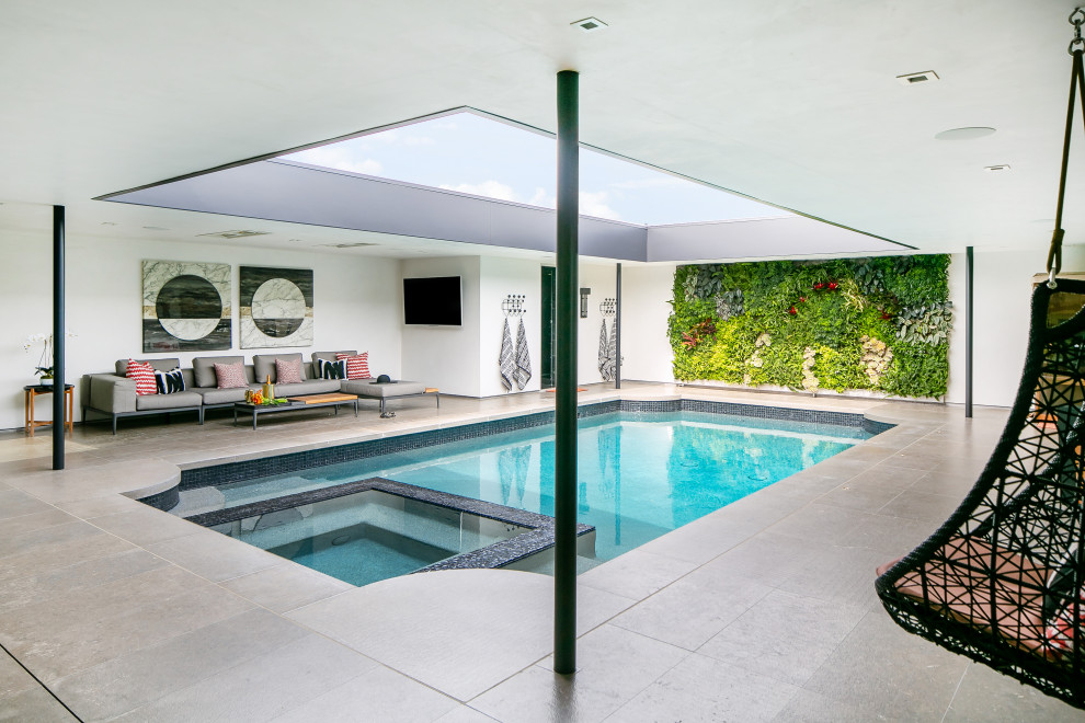 Inspiration for a contemporary courtyard rectangular pool in Orange County with a hot tub and tile.