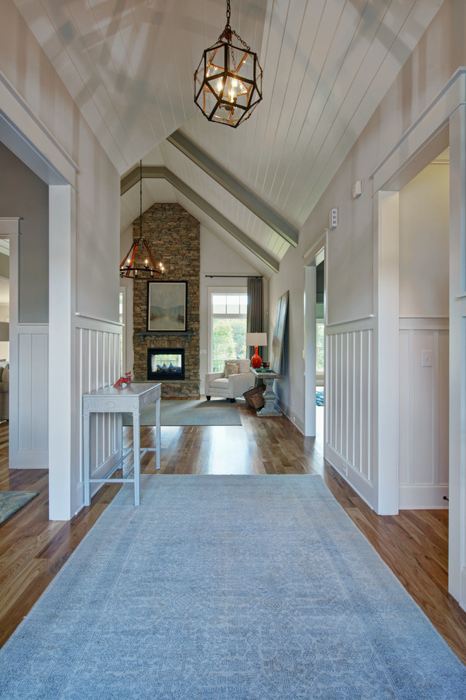This is an example of a mid-sized arts and crafts foyer in Other with a double front door, a medium wood front door, beige walls and dark hardwood floors.