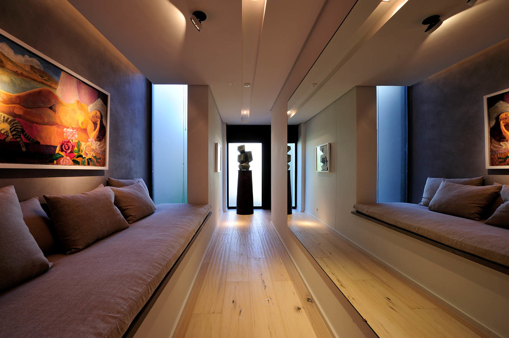 Contemporary hallway in Other with light hardwood floors.