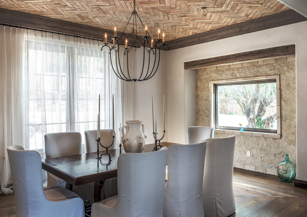 Mediterranean separate dining room in San Francisco with beige walls and dark hardwood floors.
