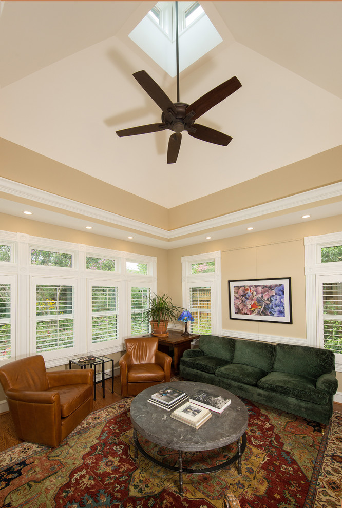 Photo of a small traditional family room in DC Metro with beige walls and light hardwood floors.