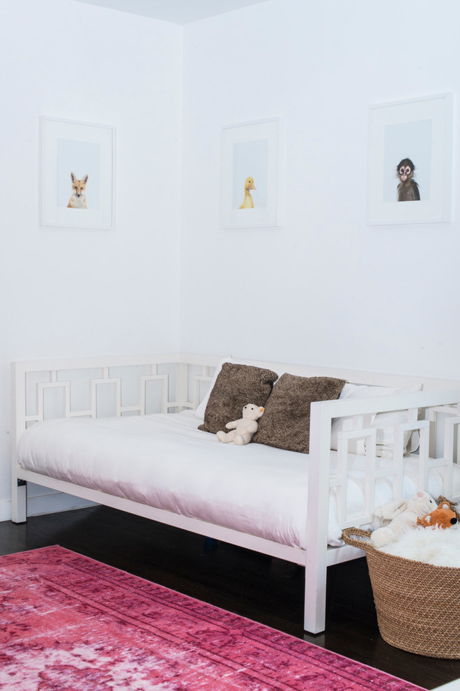 Mid-sized contemporary nursery in Los Angeles with white walls and dark hardwood floors for girls.