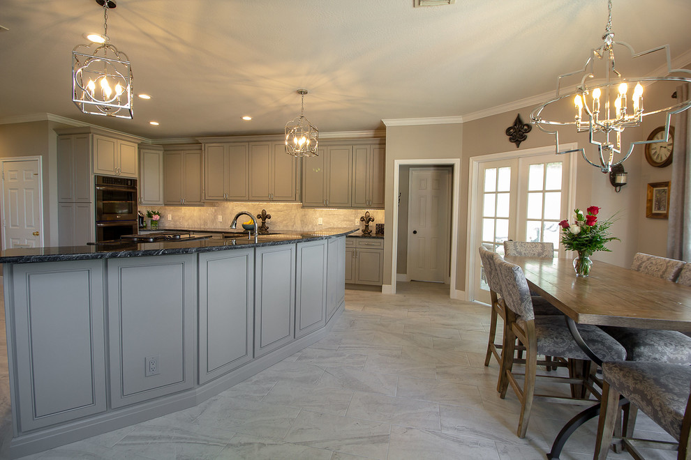 Eat-in kitchen - large transitional l-shaped porcelain tile and white floor eat-in kitchen idea in Houston with a single-bowl sink, beaded inset cabinets, gray cabinets, granite countertops, white backsplash, marble backsplash, stainless steel appliances, two islands and black countertops