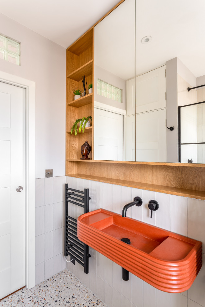 Inspiration for a small eclectic shower room bathroom in Sussex with beaded cabinets, orange cabinets, a walk-in shower, a wall mounted toilet, grey tiles, ceramic tiles, grey walls, terrazzo flooring, a wall-mounted sink, concrete worktops, orange floors, a hinged door, orange worktops, a single sink and a floating vanity unit.