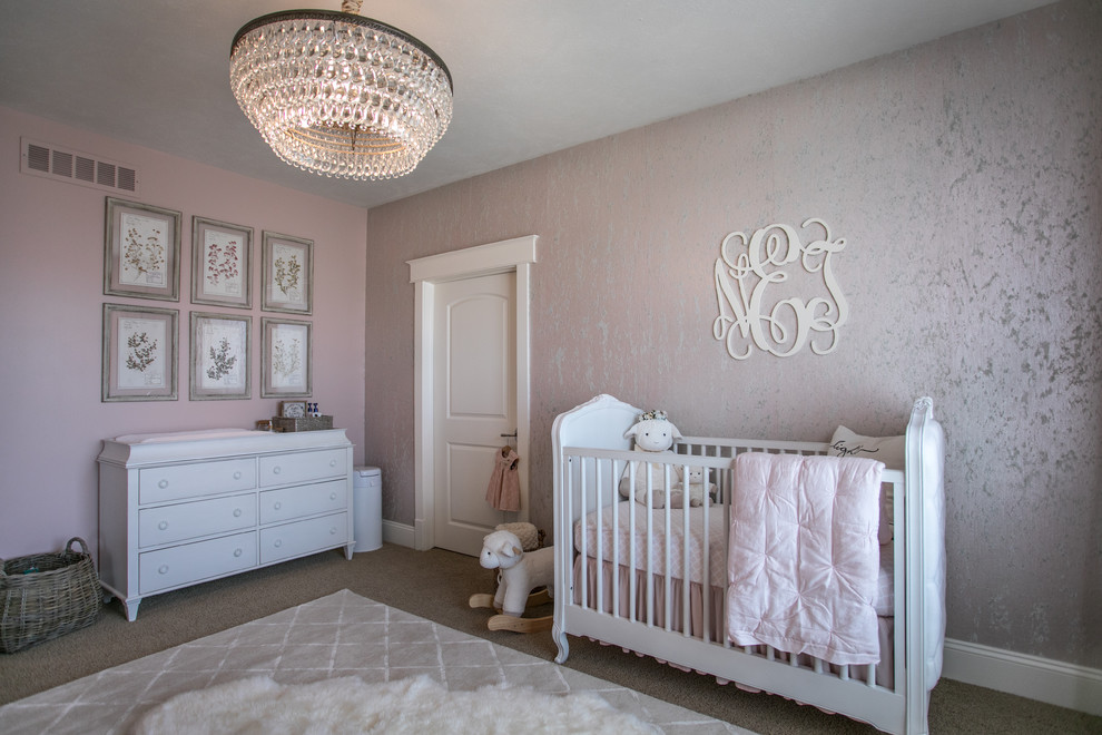 Photo of a transitional nursery for girls in Omaha with pink walls, carpet and beige floor.
