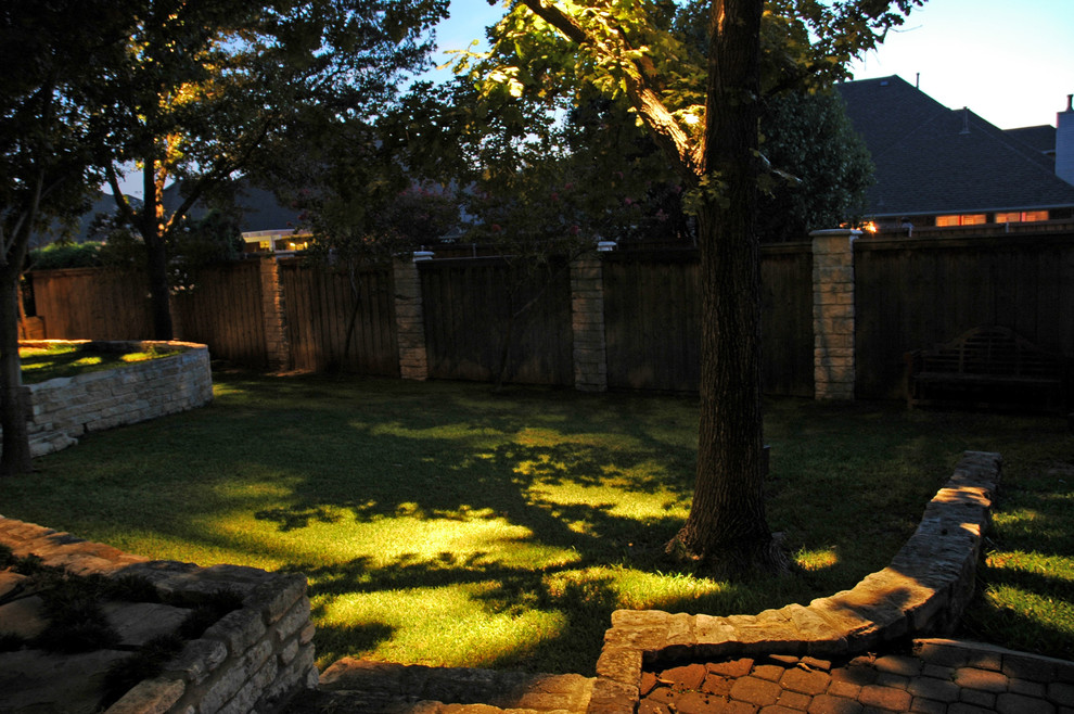 Photo of a large traditional backyard shaded formal garden in Richmond with a retaining wall and brick pavers.