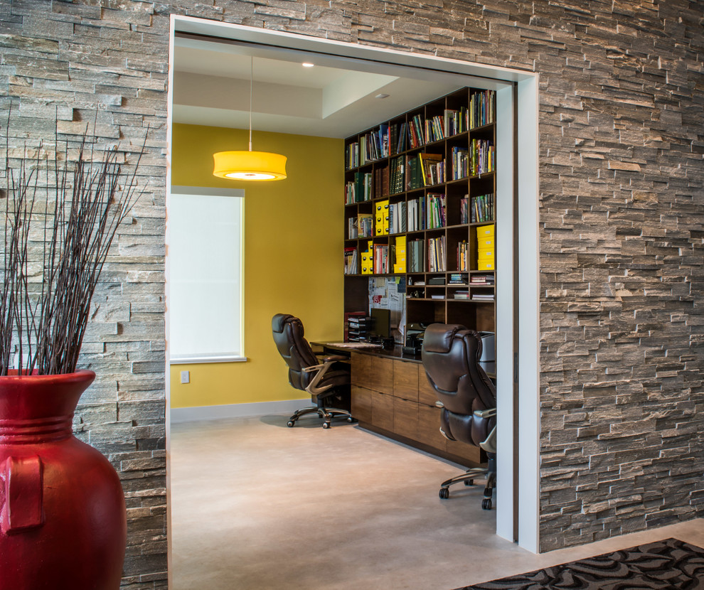 Inspiration for a contemporary home office in Houston with concrete floors.