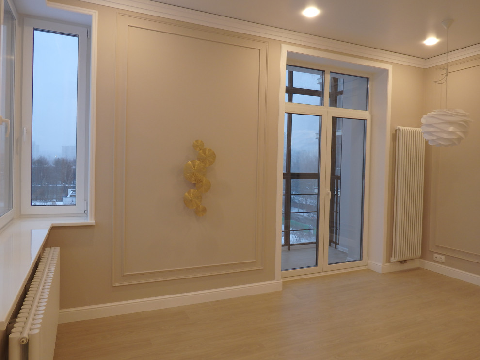 Photo of a medium sized contemporary formal enclosed living room in Moscow with beige walls, laminate floors, no fireplace, a wall mounted tv and beige floors.