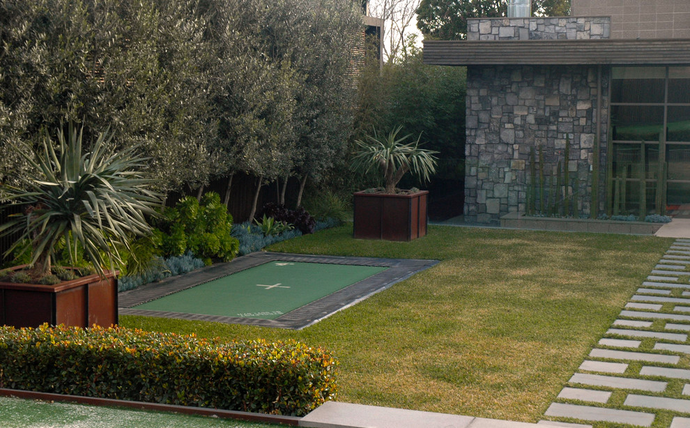 Photo of a large contemporary backyard partial sun garden in Melbourne with natural stone pavers.