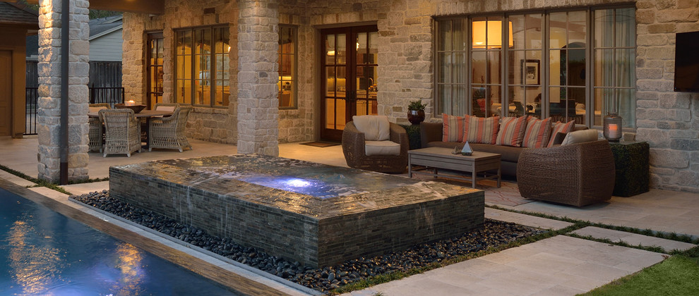 Design ideas for a mid-sized contemporary backyard rectangular natural pool in Houston with a hot tub and natural stone pavers.