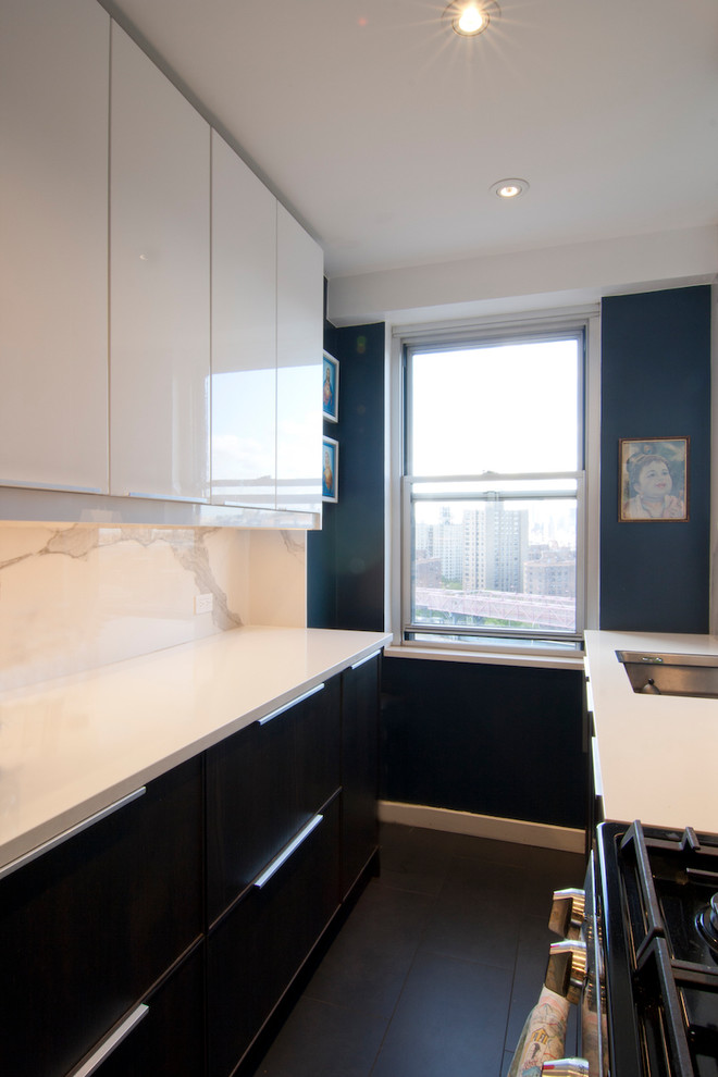 Mid-sized contemporary galley eat-in kitchen in New York with an undermount sink, flat-panel cabinets, dark wood cabinets, quartz benchtops, white splashback, stone slab splashback, stainless steel appliances, no island, painted wood floors and black floor.
