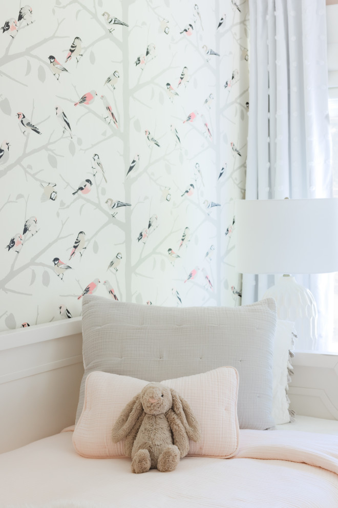 Nursery - mid-sized transitional girl light wood floor and wallpaper nursery idea in New York with pink walls