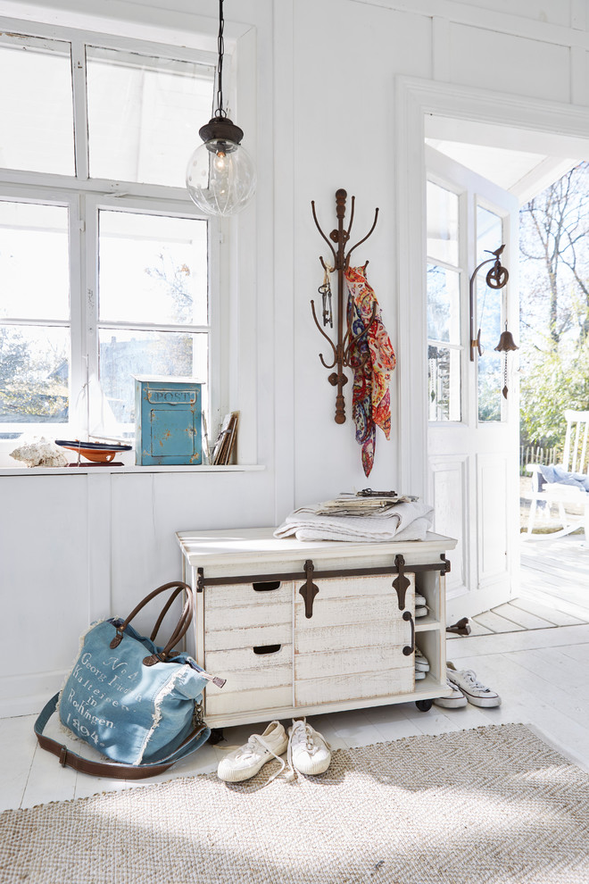Inspiration for a small beach style entry hall in Nuremberg with white walls, painted wood floors, a single front door, a white front door and white floor.