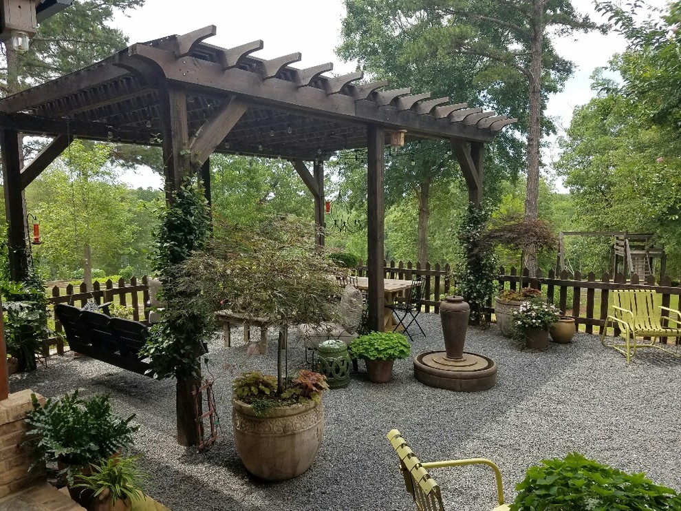 Mid-sized arts and crafts backyard patio in Atlanta with a container garden, a pergola and gravel.