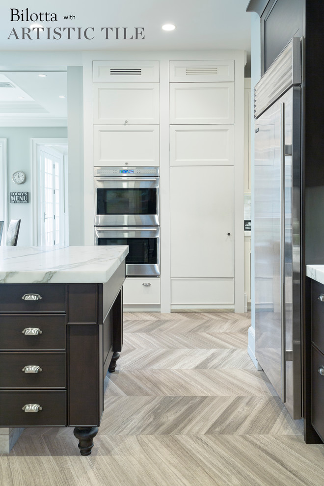 Huge u-shaped marble floor eat-in kitchen photo in New York with an undermount sink, shaker cabinets, white cabinets, marble countertops, white backsplash, stainless steel appliances and an island