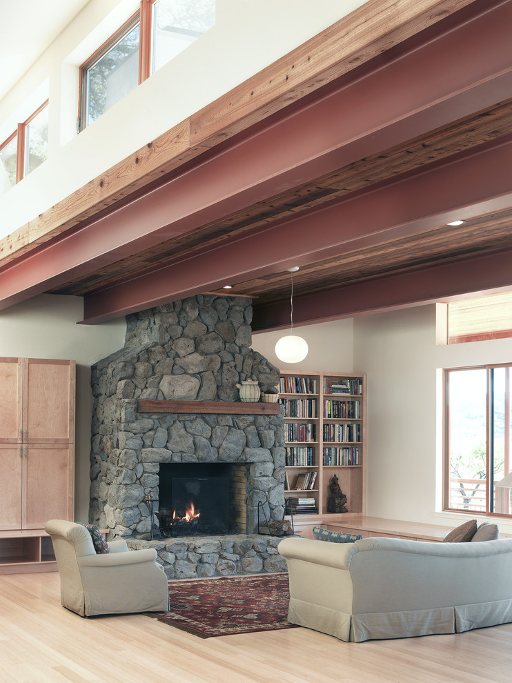 Design ideas for a country living room in San Francisco with a library and a stone fireplace surround.