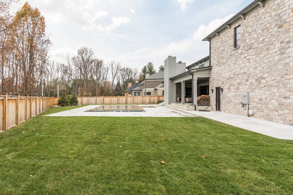 Inspiration for a large backyard concrete paver and custom-shaped pool remodel in Indianapolis