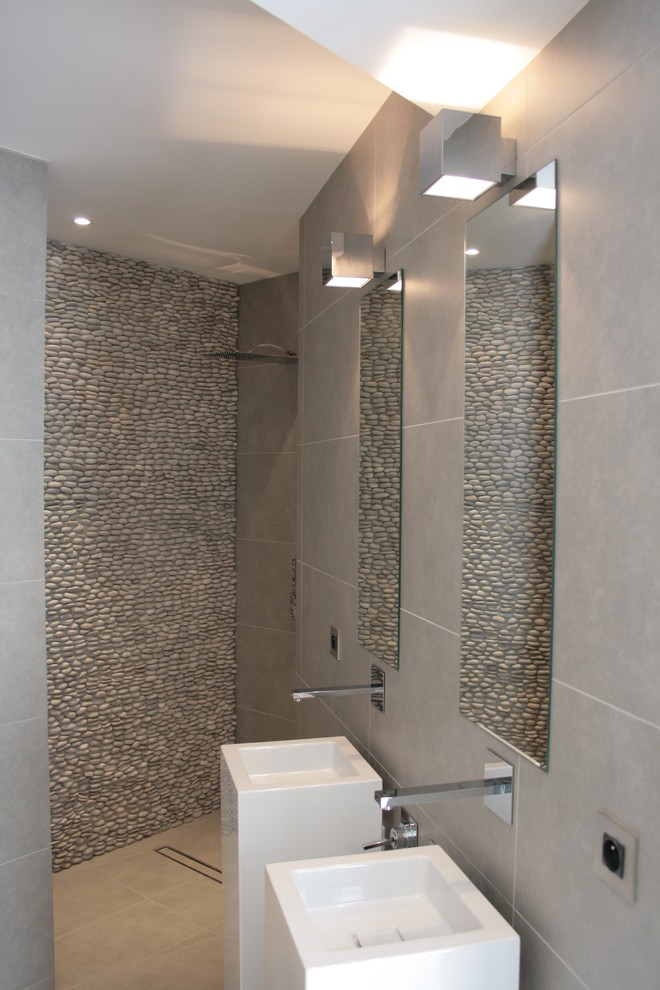 Photo of a mid-sized beach style bathroom in Other with a curbless shower, a trough sink and an open shower.