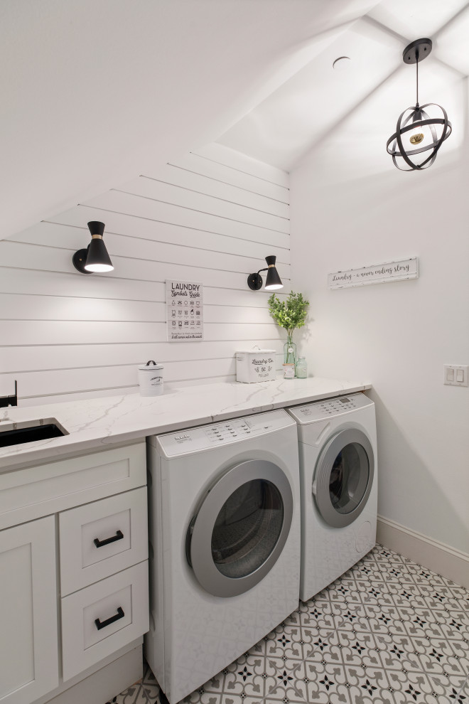 Photo of a country single-wall dedicated laundry room in Seattle with an undermount sink, shaker cabinets, white cabinets, white walls, a side-by-side washer and dryer, multi-coloured floor and multi-coloured benchtop.