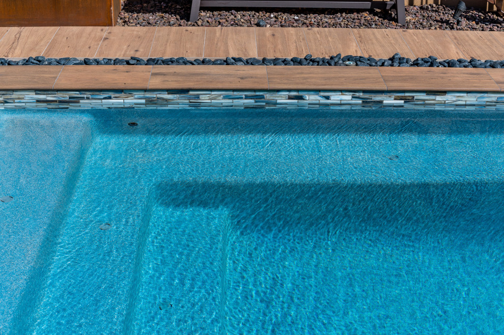 Pool - small backyard tile and rectangular pool idea in Phoenix