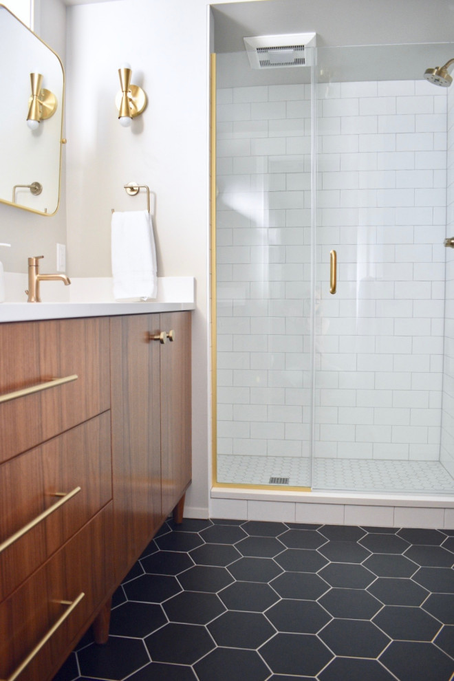 This is an example of a mid-sized midcentury 3/4 bathroom in Seattle with dark wood cabinets, an alcove shower, a two-piece toilet, white tile, subway tile, grey walls, ceramic floors, an undermount sink, engineered quartz benchtops, black floor, a hinged shower door, white benchtops and flat-panel cabinets.