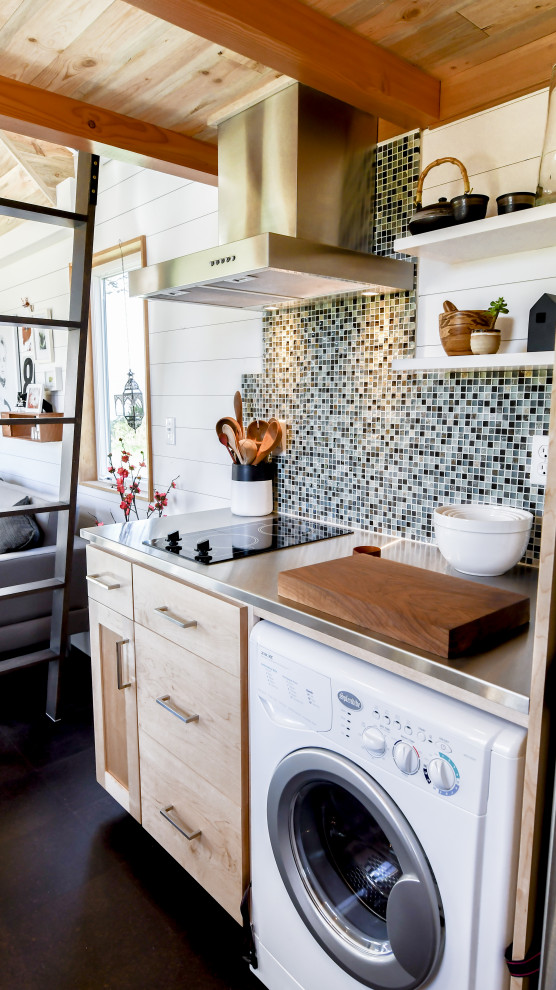Small country galley open plan kitchen in Other with an integrated sink, shaker cabinets, light wood cabinets, stainless steel benchtops, green splashback, mosaic tile splashback, cork floors, no island, black floor, grey benchtop and wood.