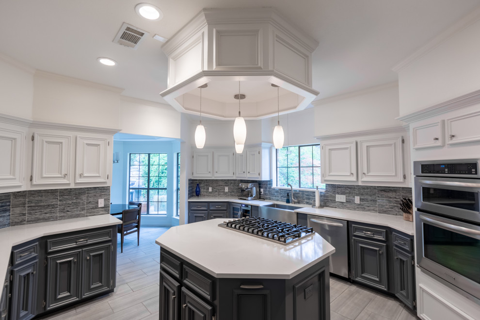 Enclosed kitchen - mid-sized transitional u-shaped ceramic tile and gray floor enclosed kitchen idea in Austin with a farmhouse sink, recessed-panel cabinets, white cabinets, quartzite countertops, blue backsplash, glass tile backsplash, stainless steel appliances, an island and white countertops
