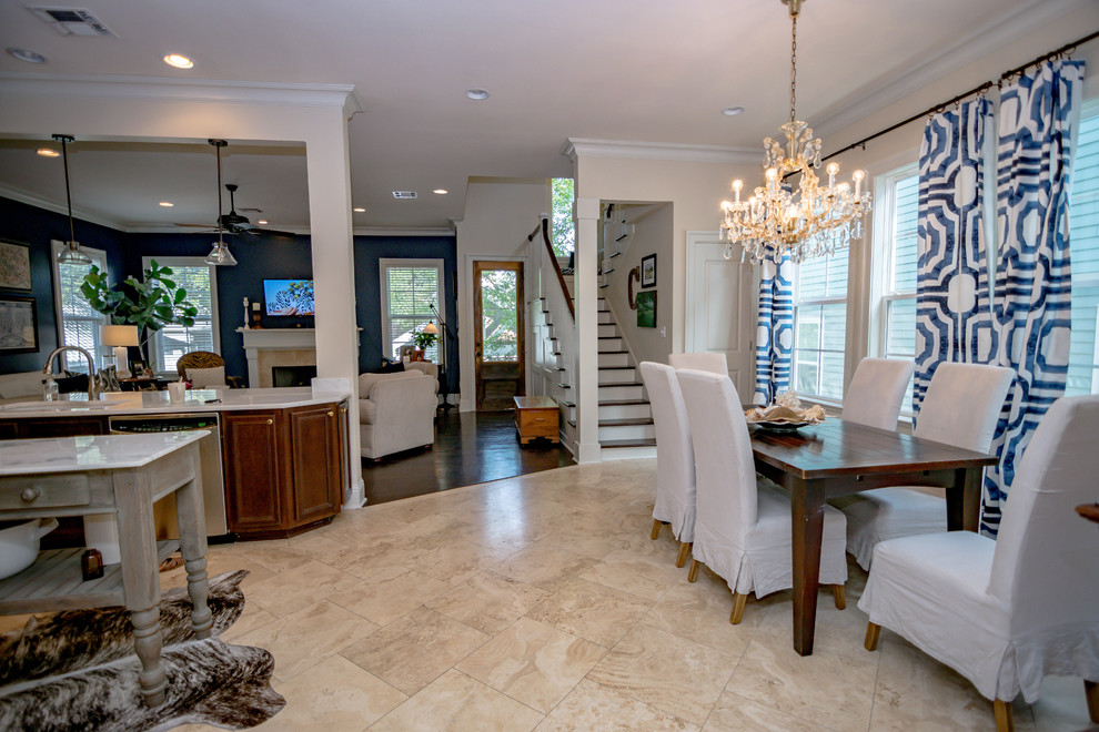 This is an example of a contemporary kitchen/dining combo in New Orleans with travertine floors and beige floor.
