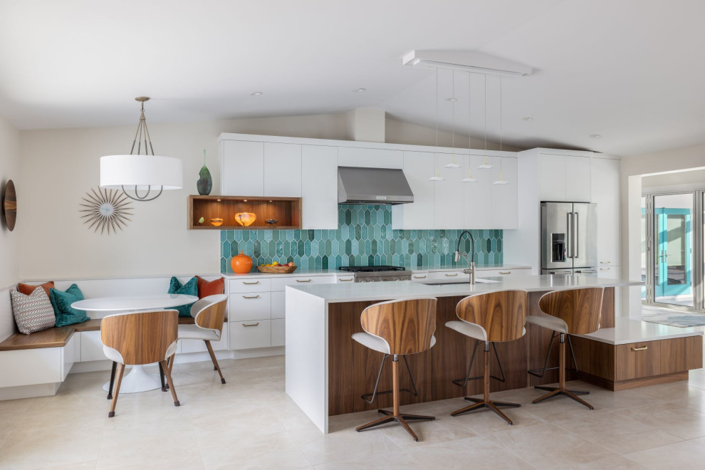 This is an example of an expansive retro galley kitchen/diner in Tampa with a submerged sink, flat-panel cabinets, white cabinets, engineered stone countertops, blue splashback, cement tile splashback, stainless steel appliances, porcelain flooring, an island, white floors, white worktops and a vaulted ceiling.