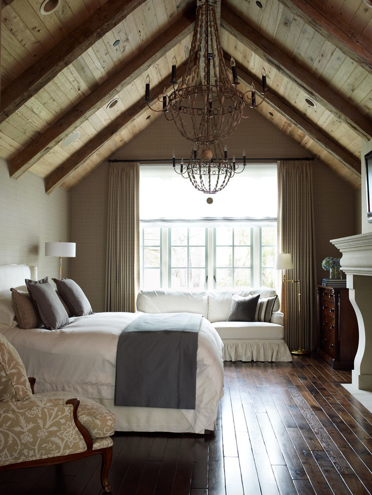 Photo of a traditional bedroom in Houston with beige walls, dark hardwood floors and a standard fireplace.