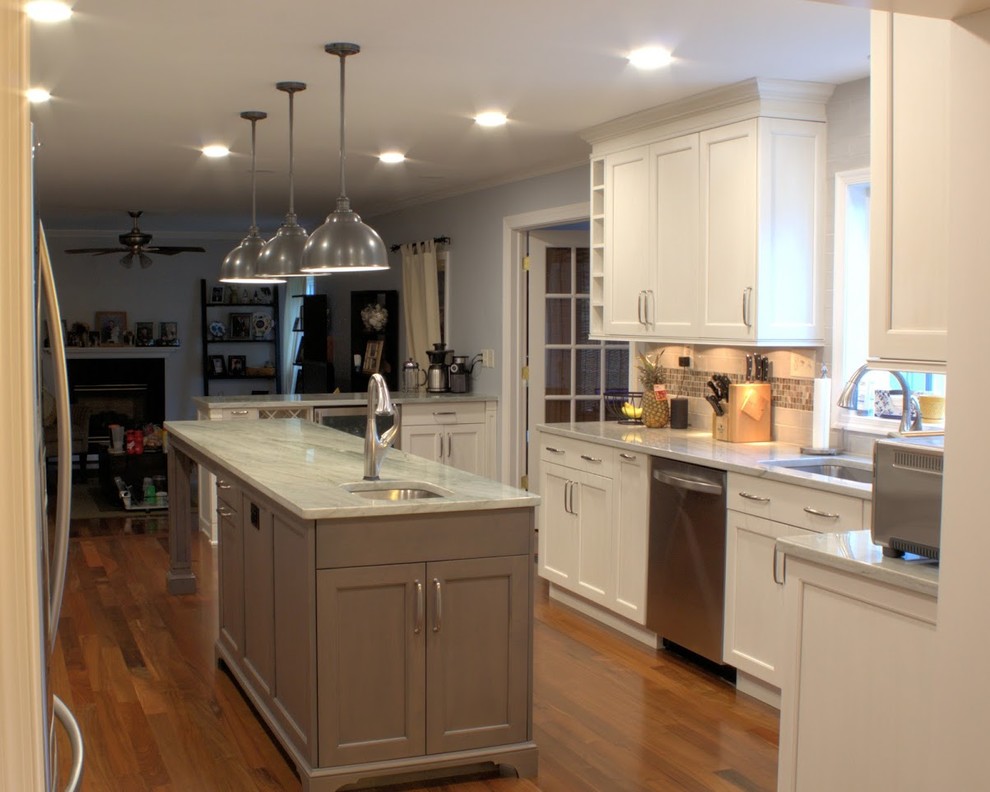 Inspiration for a large transitional galley medium tone wood floor and brown floor eat-in kitchen remodel in Baltimore with a single-bowl sink, recessed-panel cabinets, white cabinets, quartzite countertops, gray backsplash, glass tile backsplash, stainless steel appliances, an island and multicolored countertops