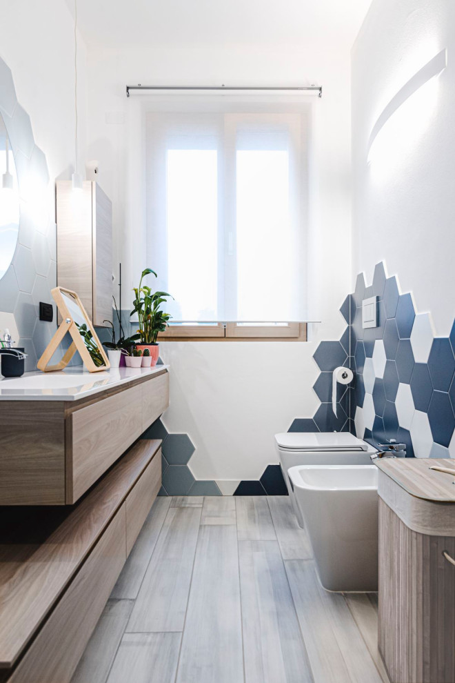 Inspiration for a mid-sized contemporary 3/4 bathroom in Other with light wood cabinets, blue tile, ceramic tile, white walls, porcelain floors, an integrated sink, a sliding shower screen, white benchtops, a single vanity and a floating vanity.