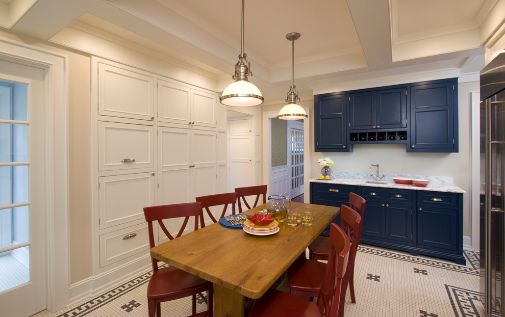 Mid-sized traditional u-shaped eat-in kitchen in New York with an undermount sink, beaded inset cabinets, blue cabinets, marble benchtops, white splashback, stone tile splashback, panelled appliances and ceramic floors.