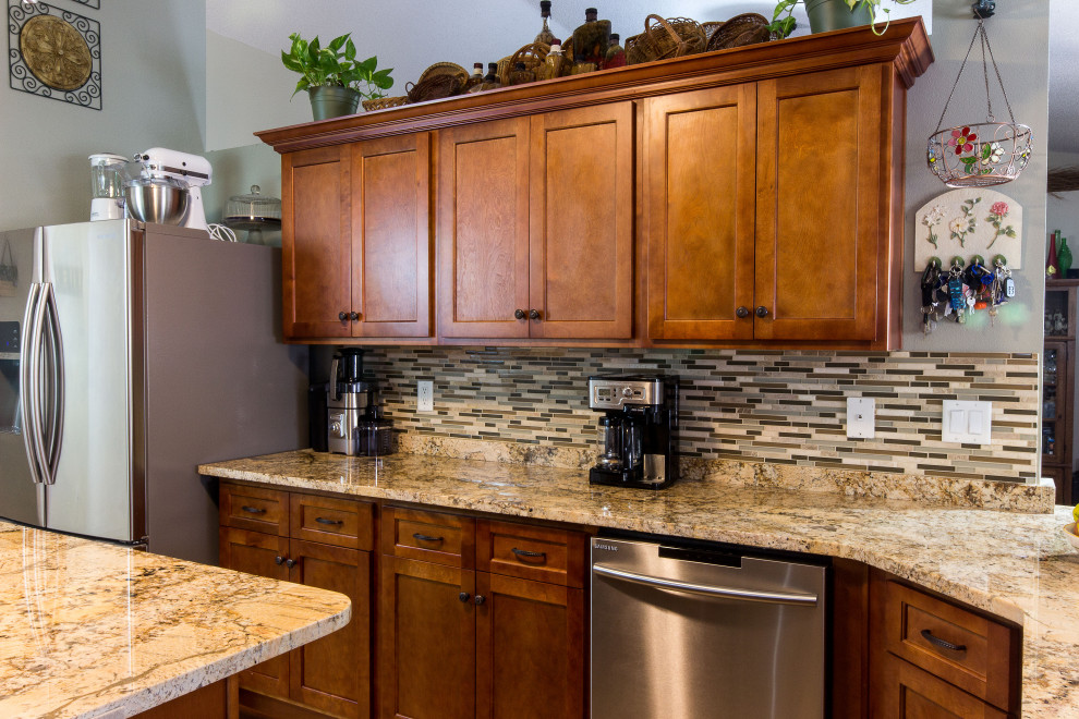 Inspiration for a mid-sized galley cement tile floor and beige floor eat-in kitchen remodel with an undermount sink, shaker cabinets, medium tone wood cabinets, granite countertops, multicolored backsplash, glass sheet backsplash, stainless steel appliances, an island and beige countertops