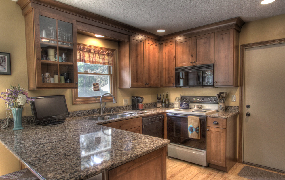 Inspiration for a mid-sized rustic u-shaped light wood floor eat-in kitchen remodel with an undermount sink, shaker cabinets, medium tone wood cabinets, quartz countertops, black appliances and a peninsula