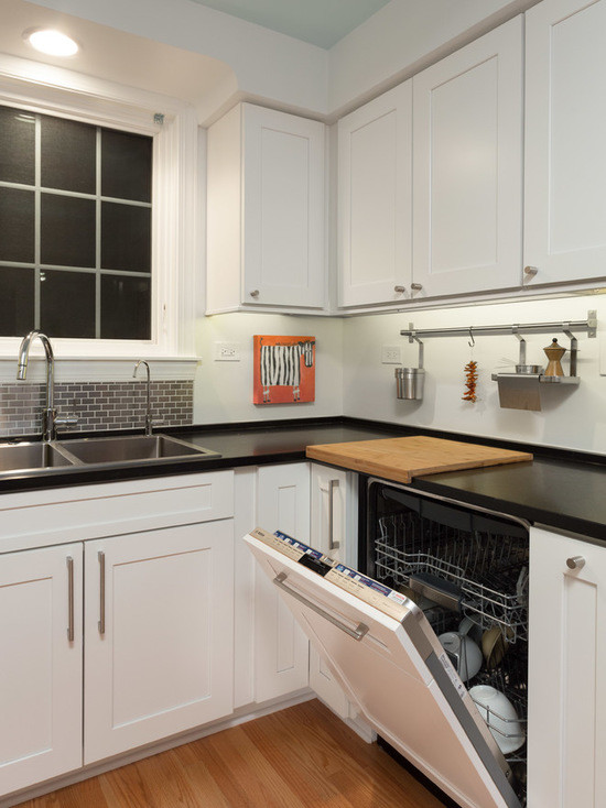 Mid-sized transitional u-shaped medium tone wood floor enclosed kitchen photo in Chicago with a double-bowl sink, shaker cabinets, white cabinets, quartzite countertops, gray backsplash, subway tile backsplash, stainless steel appliances and no island