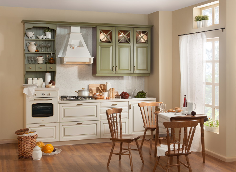 Inspiration for a small traditional single-wall separate kitchen in Moscow with a single-bowl sink, raised-panel cabinets, green cabinets, laminate benchtops, beige splashback, coloured appliances, laminate floors, no island, brown floor and beige benchtop.