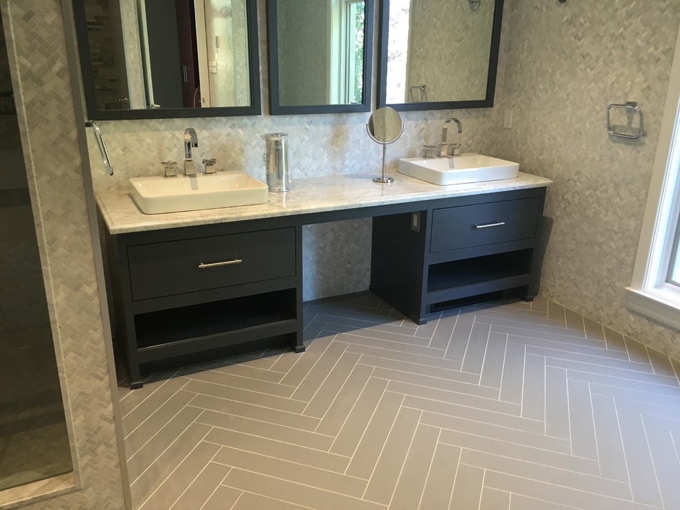 Photo of a large contemporary master bathroom in Toronto with flat-panel cabinets, grey cabinets, an alcove shower, gray tile, porcelain tile, multi-coloured walls, porcelain floors, a vessel sink and marble benchtops.